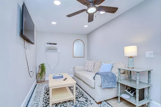 a living room with a couch and a chandelier