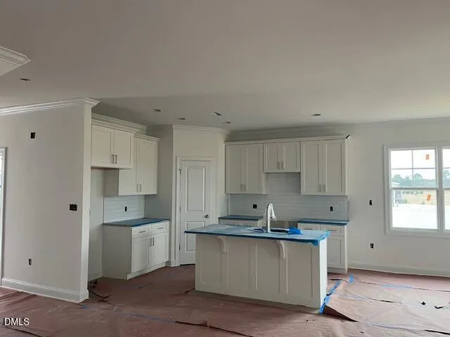a kitchen with granite countertop white cabinets and white appliances