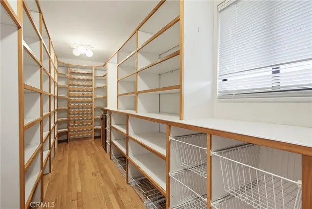 a view of a room with wooden floor and large window
