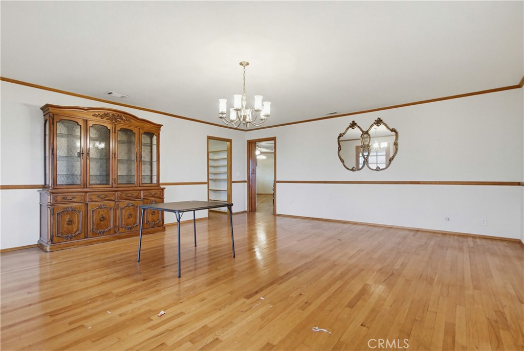 11905 Sierra Rojo Road Valley Center, CA 92082 - Photo 21 of 65 a view of a room with wooden floor chandelier and windows