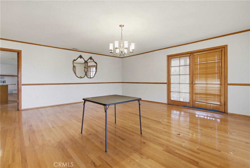 11905 Sierra Rojo Road Valley Center, CA 92082 - Photo 22 of 65 a view of a room with wooden floor and large window