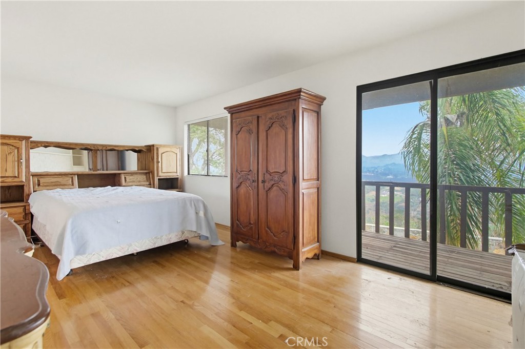11905 Sierra Rojo Road Valley Center, CA 92082 - Photo 25 of 65 a bedroom with a large bed and a large window