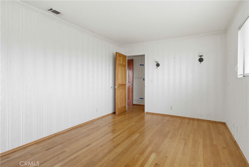 11905 Sierra Rojo Road Valley Center, CA 92082 - Photo 28 of 65 a view of an empty room with wooden floor and closet