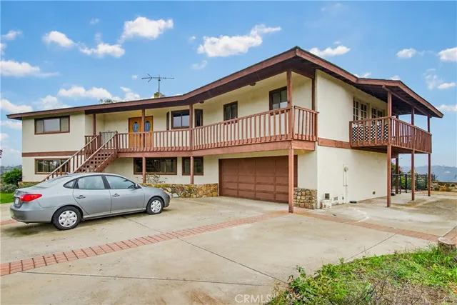 a front view of a house with parking space