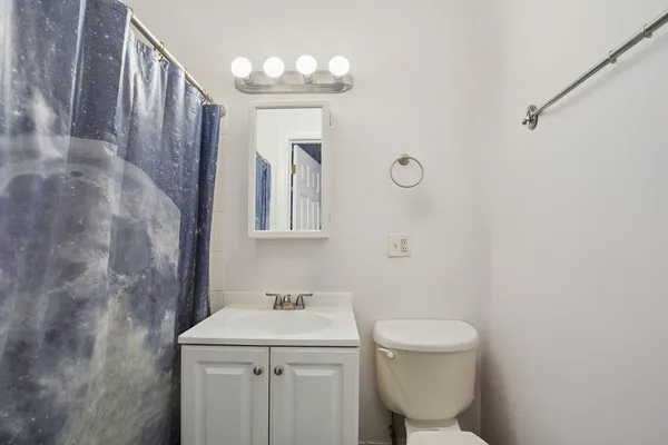 a view of washer and dryer with bathroom in the background