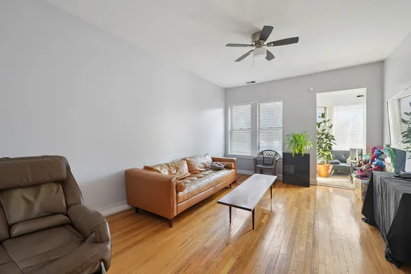a bed room with a bed and a ceiling fan