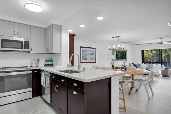a view of a dining room with furniture and chandelier