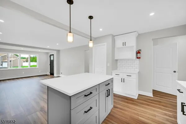 a kitchen with a stove a refrigerator and a sink