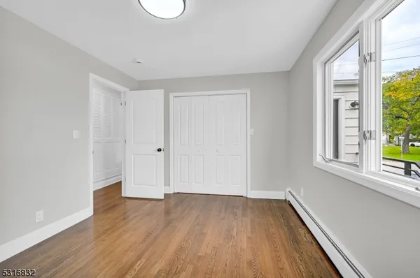 a view of a room with wooden floor and windows