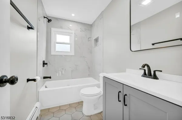 a bathroom with a sink a toilet and a tub