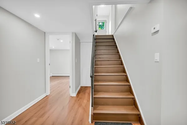 a view of an entryway with wooden floor