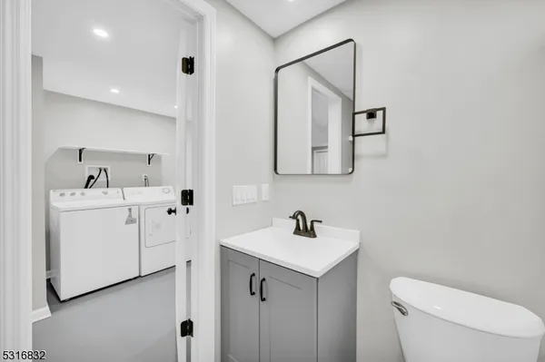 a bathroom with a toilet sink and mirror