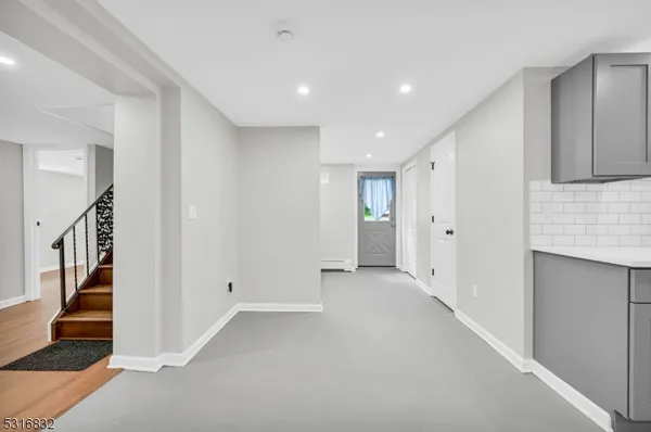 a view of an empty room with stairs and ventilation