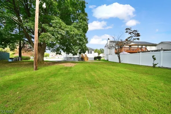 a view of a backyard with large trees