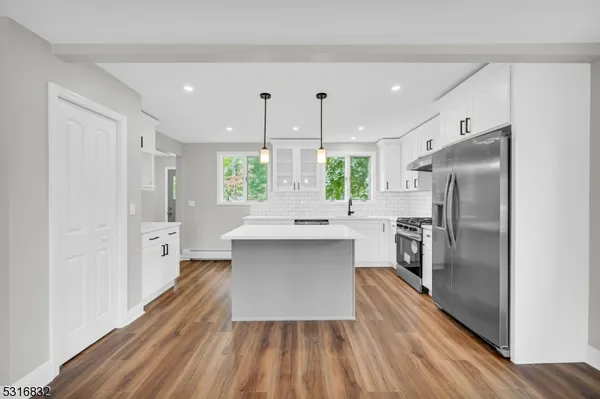 a kitchen with a refrigerator and a sink