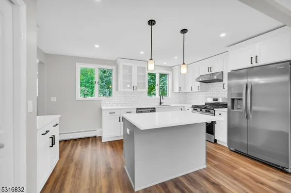 a kitchen with a sink refrigerator and window