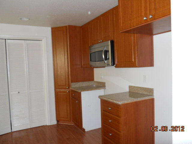 1883 Agnew Road, Unit 431 Santa Clara, CA 95054 - Photo 3 of 8 a kitchen with stainless steel appliances wooden cabinets and a refrigerator