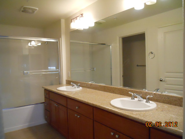 1883 Agnew Road, Unit 431 Santa Clara, CA 95054 - Photo 5 of 8 a bathroom with a granite countertop sink and a mirror