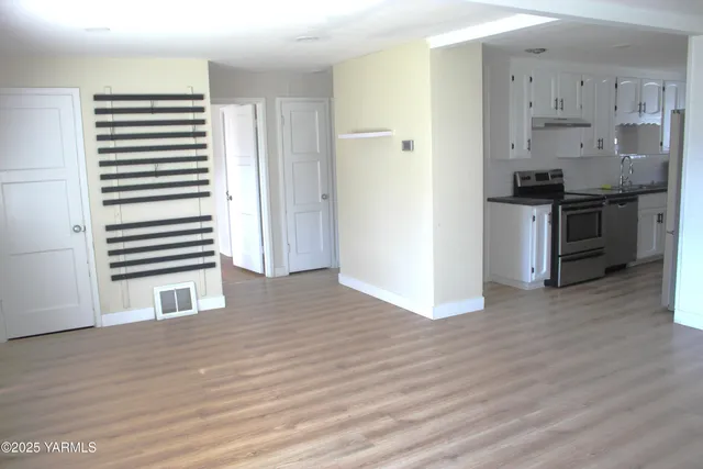 a kitchen with stainless steel appliances a refrigerator and a stove top oven