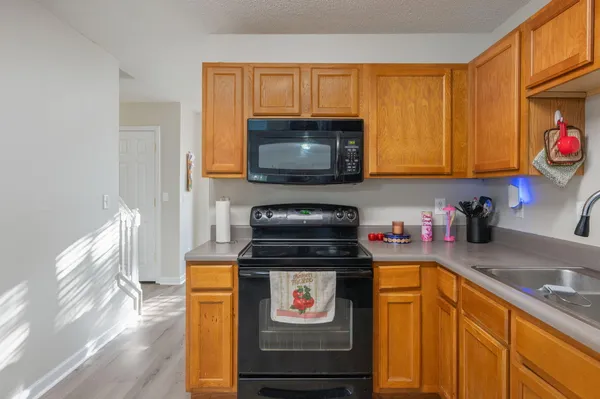 a kitchen with a stove a sink and a microwave