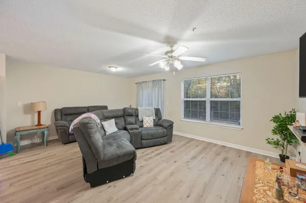 a living room with furniture and a large window