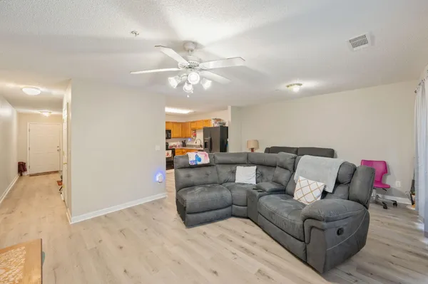 a living room with furniture and a chandelier