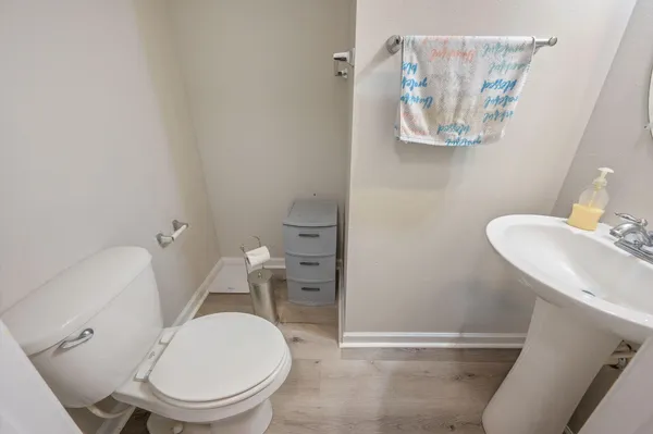 a white toilet sitting next to a bathroom sink