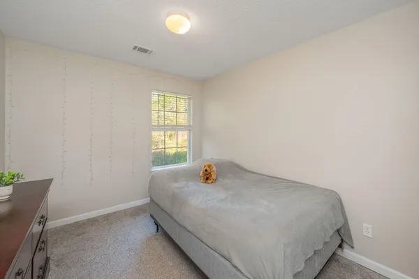 a bedroom with a bed and window