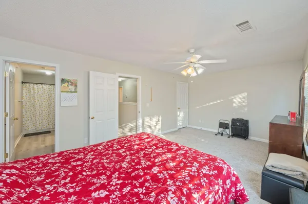 a bedroom with a bed and a chandelier