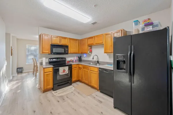 a kitchen with stainless steel appliances granite countertop a refrigerator stove and oven
