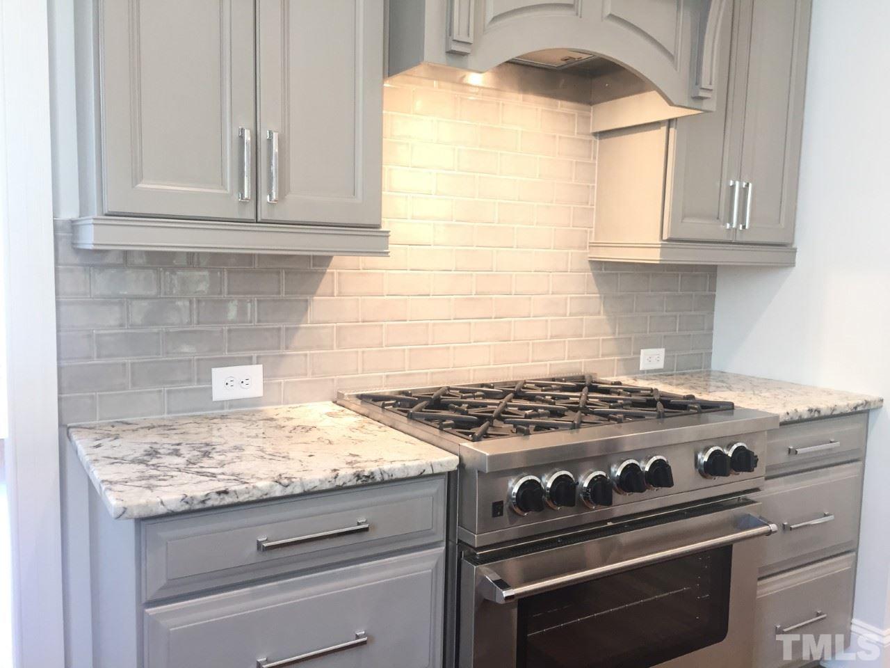 8800 Breeland Way Raleigh, NC 27613 - Photo 12 of 24 a stove top oven sitting inside of a kitchen