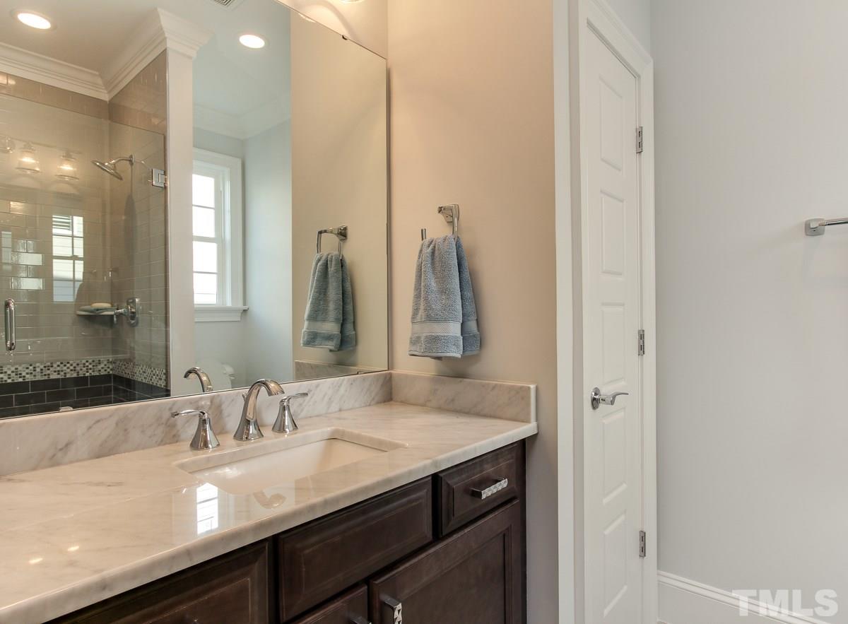 8800 Breeland Way Raleigh, NC 27613 - Photo 15 of 24 a bathroom with a granite countertop sink and a mirror