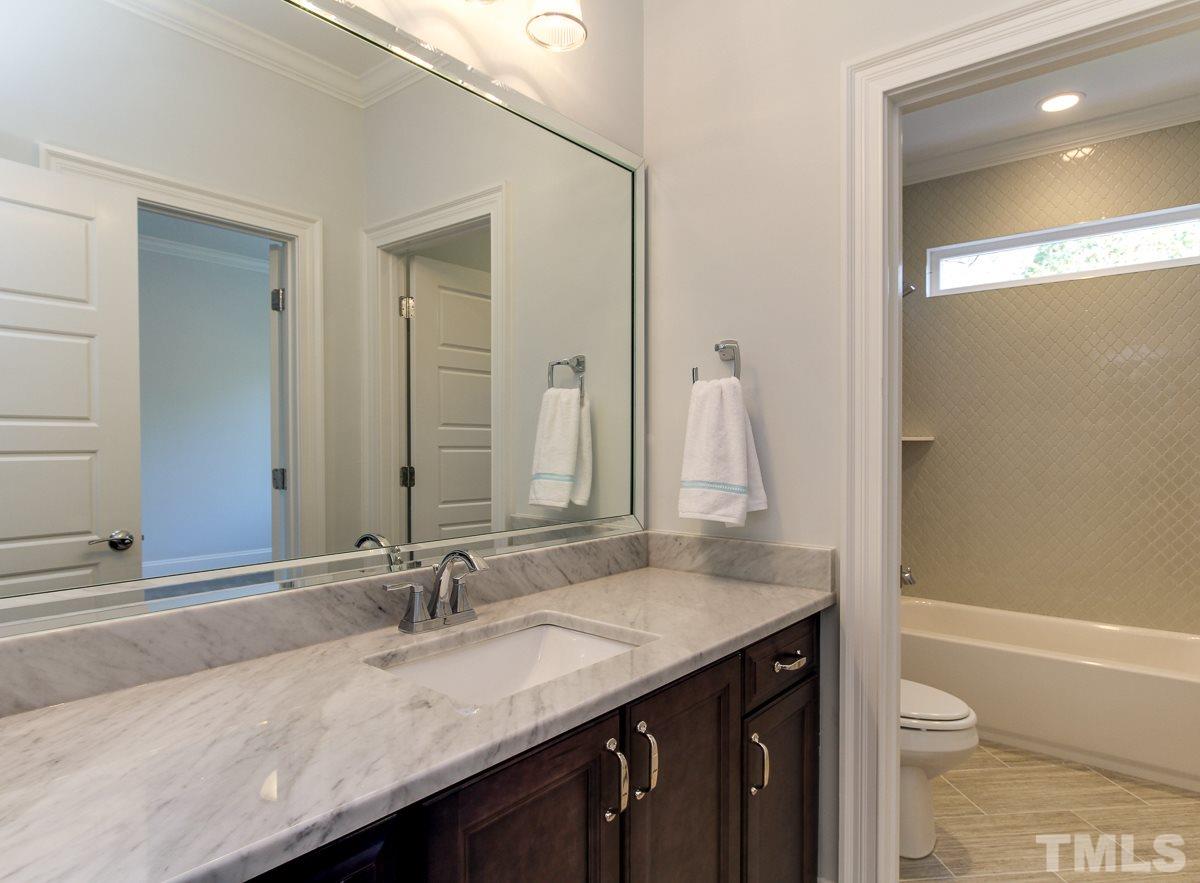 8800 Breeland Way Raleigh, NC 27613 - Photo 19 of 24 a bathroom with a granite countertop sink and a mirror