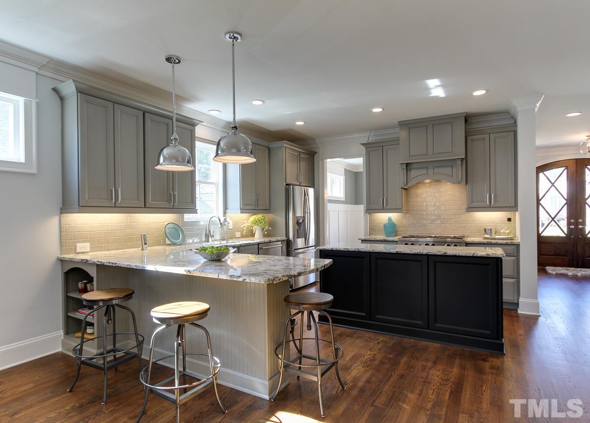8800 Breeland Way Raleigh, NC 27613 - Photo 4 of 24 a kitchen with granite countertop kitchen island cabinets and wooden floor
