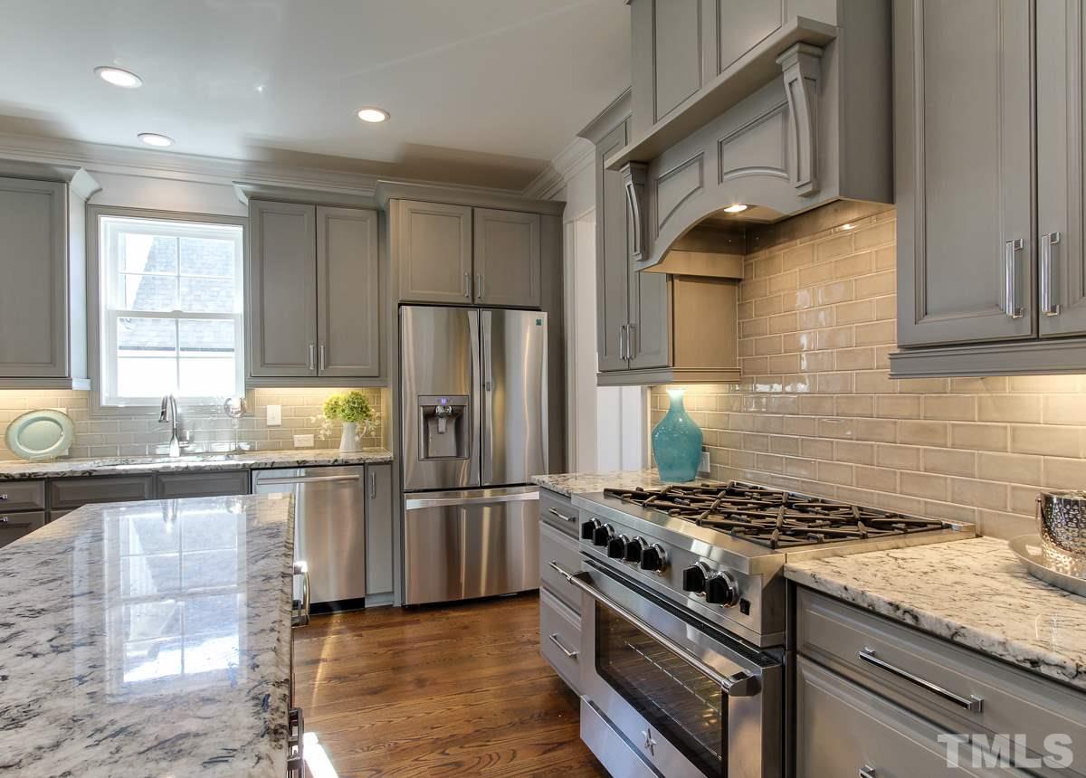 8800 Breeland Way Raleigh, NC 27613 - Photo 5 of 24 a kitchen with granite countertop a sink stainless steel appliances and cabinets