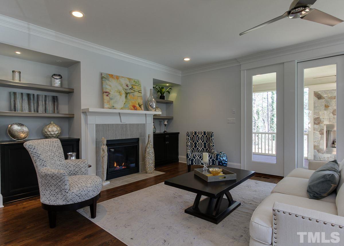 8800 Breeland Way Raleigh, NC 27613 - Photo 7 of 24 a living room with furniture and a fireplace