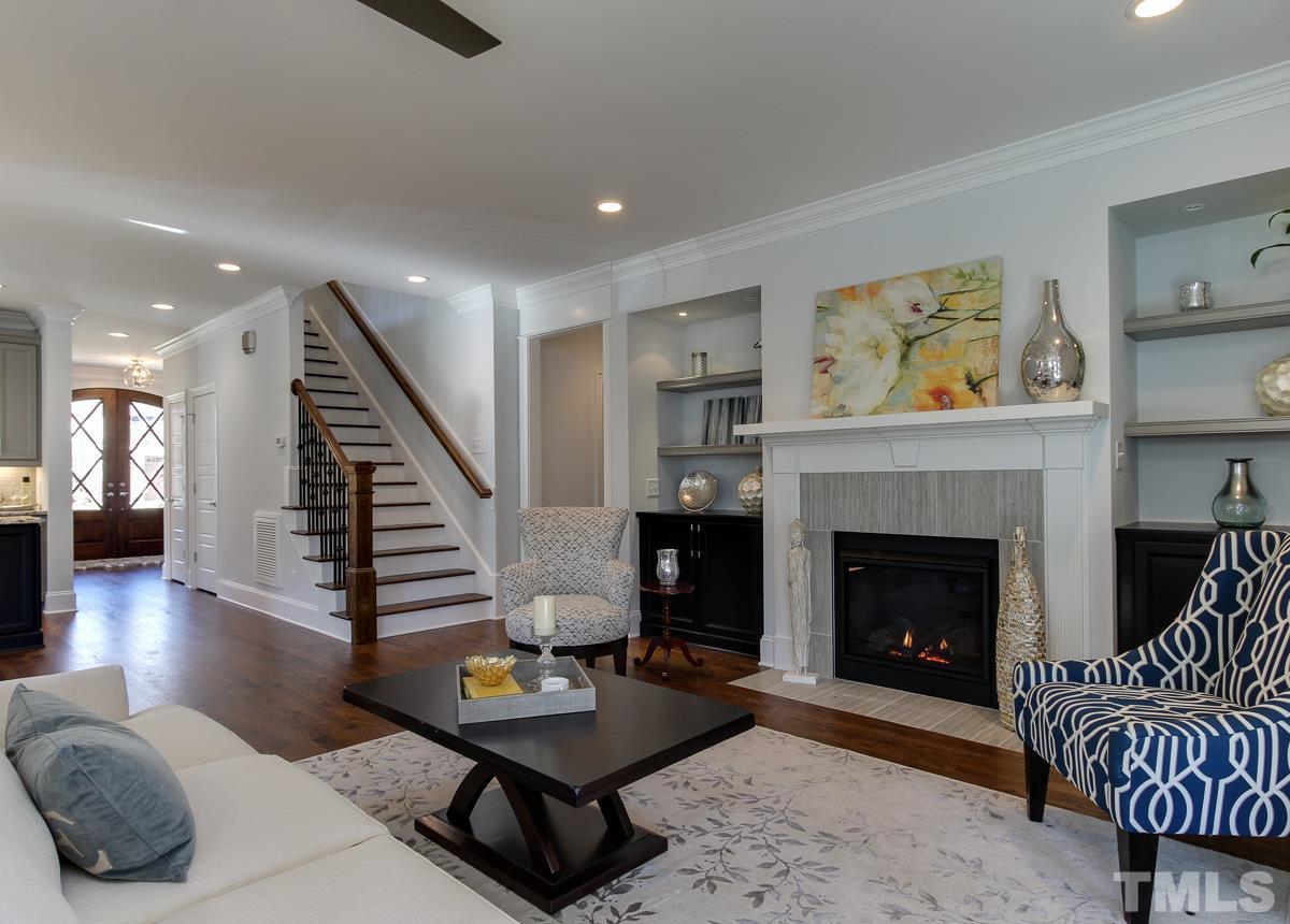 8800 Breeland Way Raleigh, NC 27613 - Photo 10 of 24 a living room with furniture and a fireplace