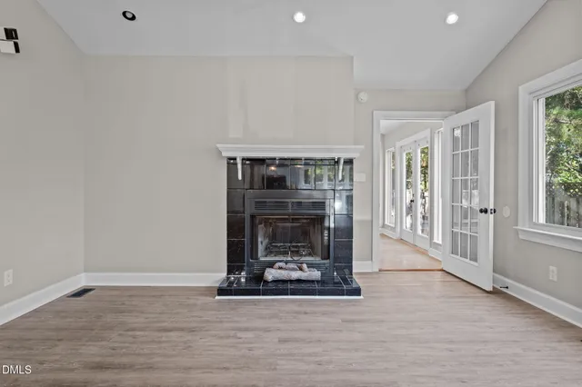 a bedroom with a bed mirror and window