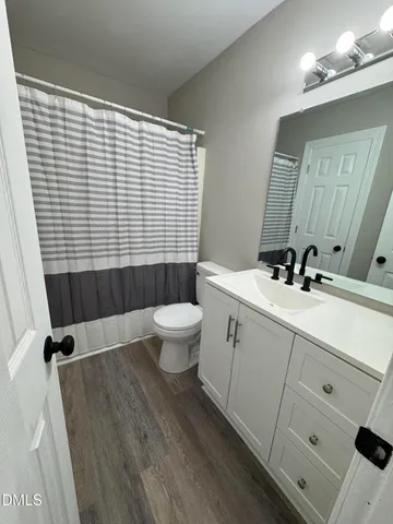 a view of an empty room and wooden floor