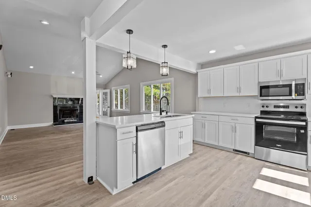 a kitchen with a refrigerator stove and sink