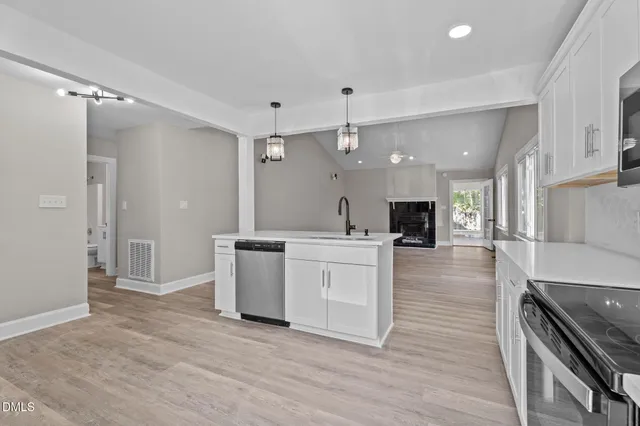 a kitchen with stainless steel appliances granite countertop a stove and cabinets