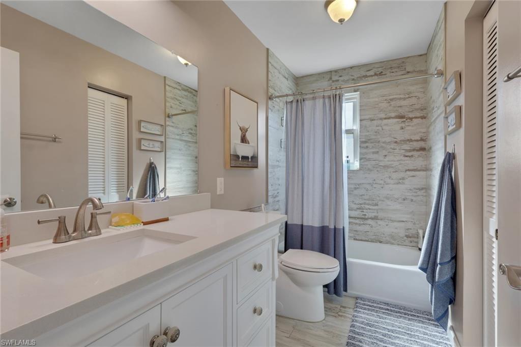 5092 Boxwood Way Naples, FL 34116 - Photo 18 of 48 a bathroom with a bathtub shower sink vanity and toilet