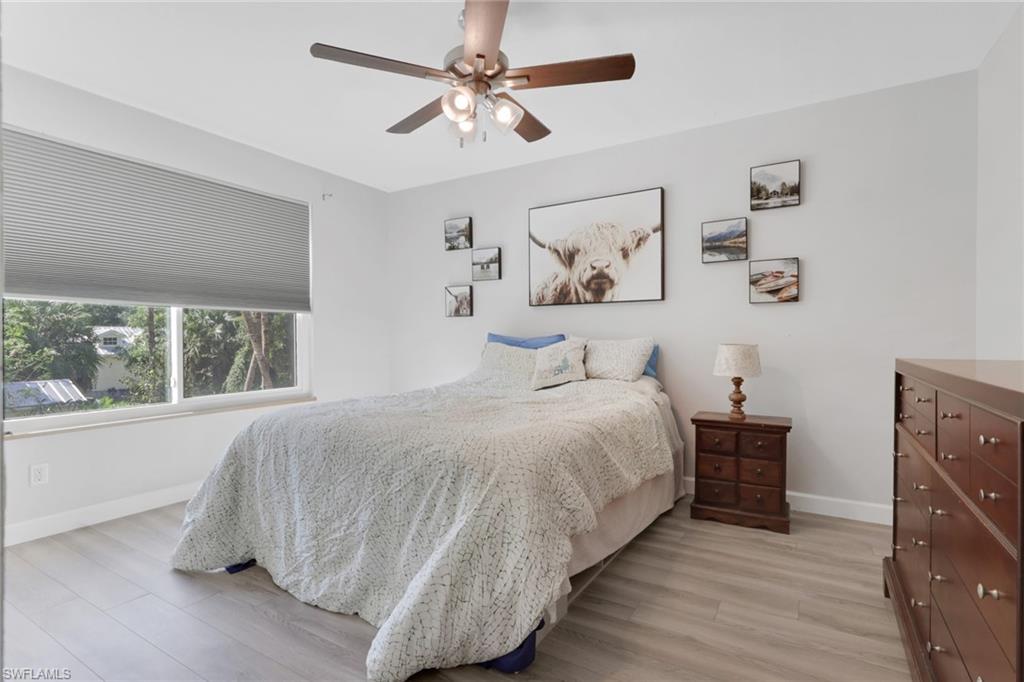 5092 Boxwood Way Naples, FL 34116 - Photo 19 of 48 a bedroom with a bed and a window