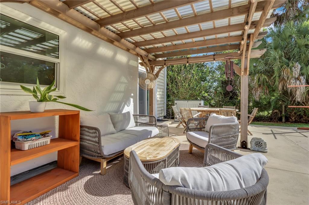 5092 Boxwood Way Naples, FL 34116 - Photo 22 of 48 a outdoor living space with patio furniture and a potted plant