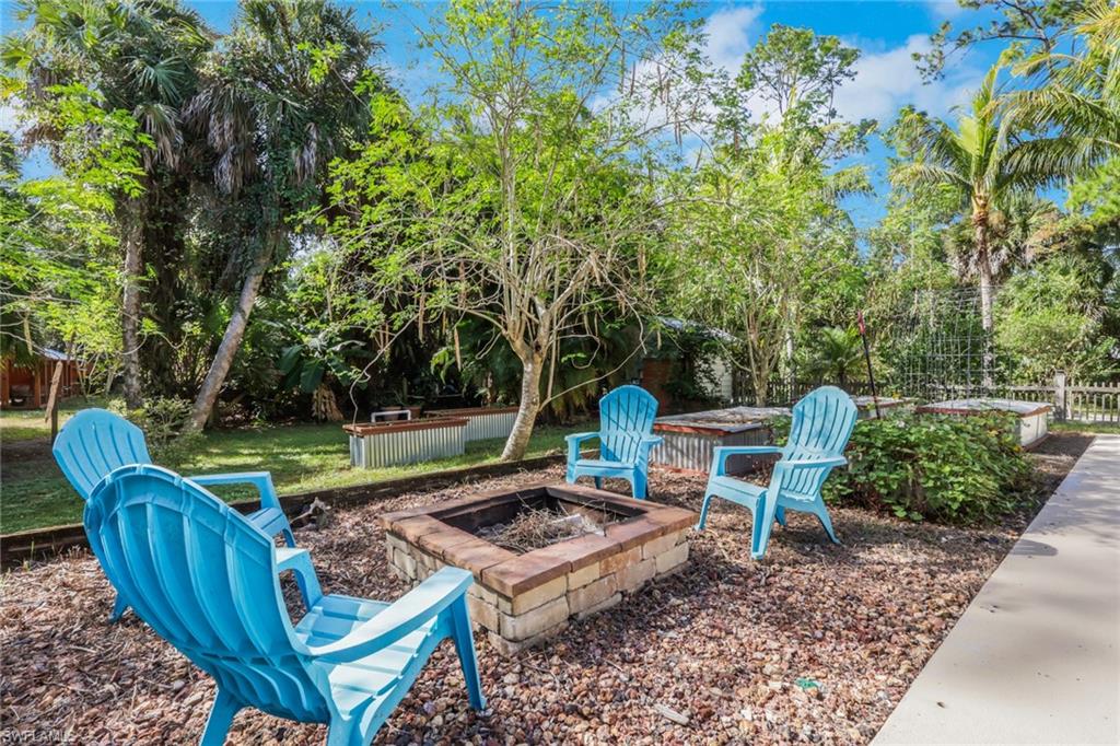 5092 Boxwood Way Naples, FL 34116 - Photo 26 of 48 Firepit area and raised garden beds in the backyard off the large patio/pool area- Ideal space for entertaining!
