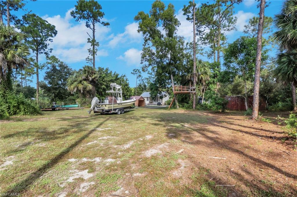 5092 Boxwood Way Naples, FL 34116 - Photo 32 of 48 Cleared area in the rear of the lot with a treehouse and zipline! Great space to park your boats, RVS, work trucks, Etc.