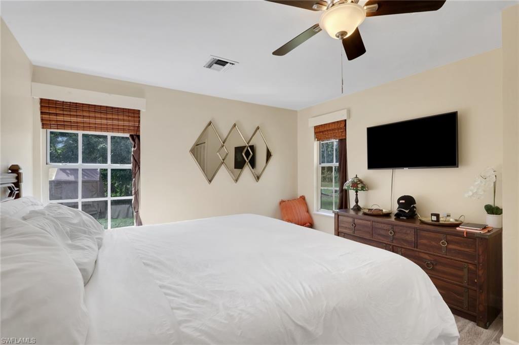5092 Boxwood Way Naples, FL 34116 - Photo 40 of 48 a bedroom with a bed and a flat screen tv