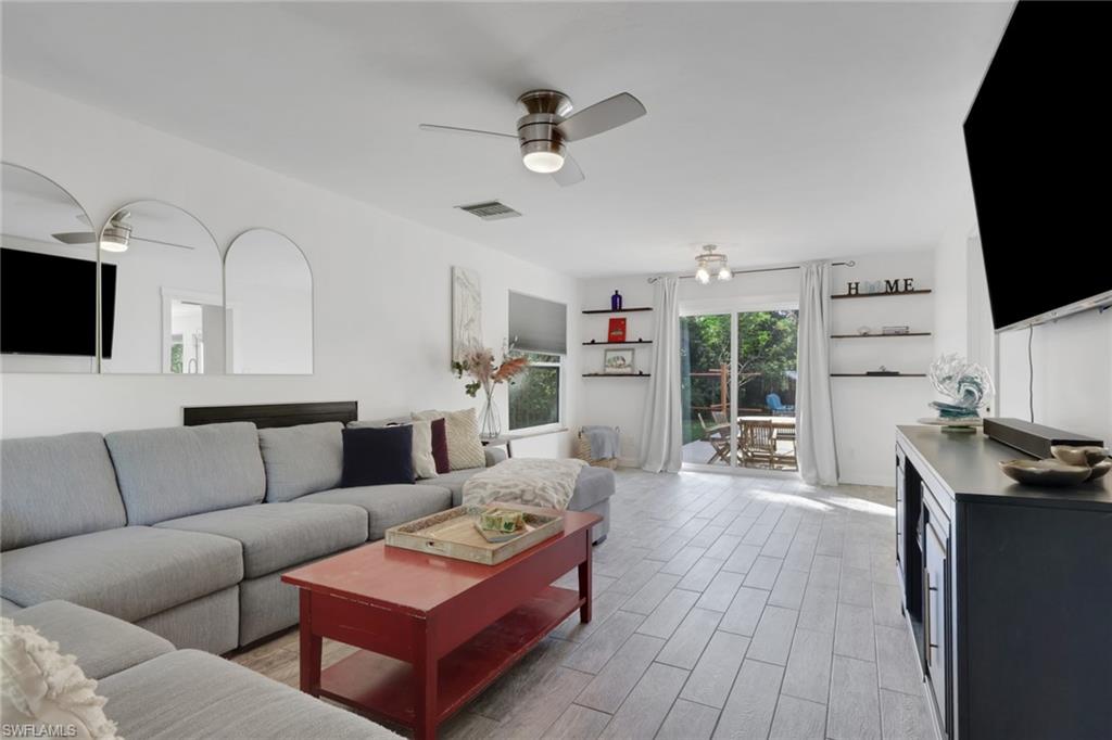 5092 Boxwood Way Naples, FL 34116 - Photo 4 of 48 a living room with furniture and a flat screen tv