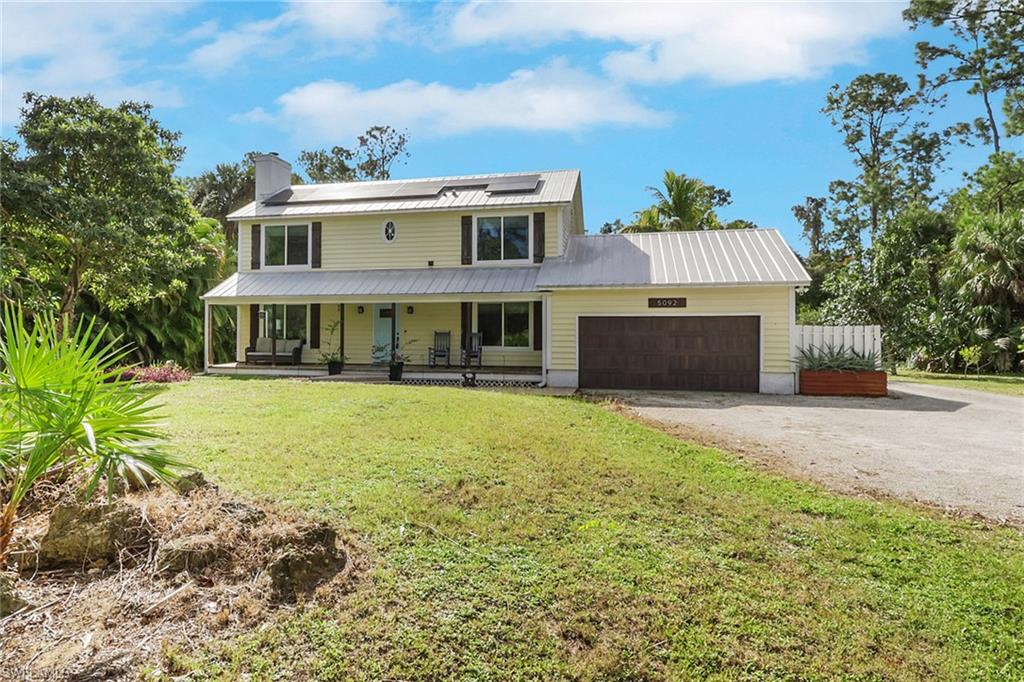 5092 Boxwood Way Naples, FL 34116 - Photo 44 of 48 Beautiful two story home with a lovely porch along the front of the home, newer metal roof on all structures, brand new solar panels. This home has beautiful curb appeal and is one of a kind