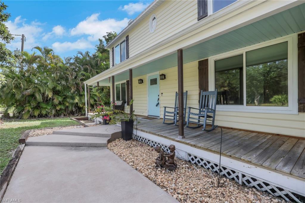 5092 Boxwood Way Naples, FL 34116 - Photo 47 of 48 This two-story home greets you with a large wood deck along the front of the home. Sit and enjoy your morning coffee or relax and enjoy the sunset with your favorite beverage